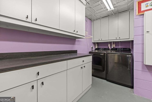 4 W Wesley Rdg NW, Atlanta, GA 30327 - kitchen with washing machine and dryer, white cabinetry, dark countertops, finished concrete floors, and an ornate ceiling