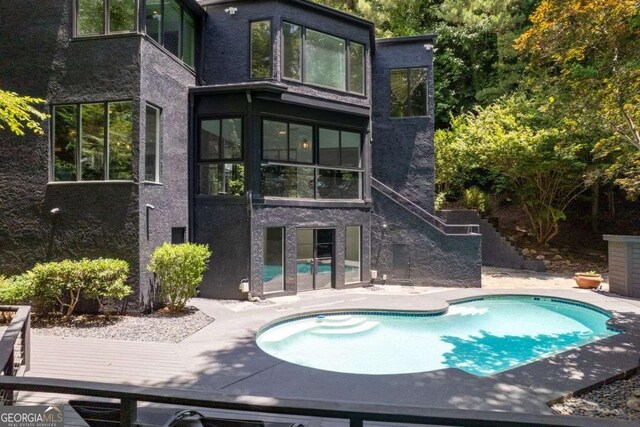 4 W Wesley Rdg NW, Atlanta, GA 30327 - back of property with an outdoor pool, a patio area, and stucco siding