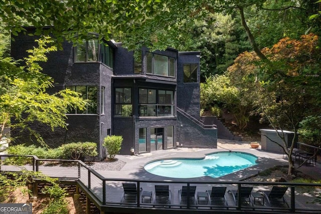 4 W Wesley Rdg NW, Atlanta, GA 30327 - back of house featuring stairway, an outdoor pool, a wooden deck, and a patio