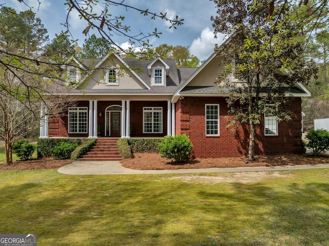 11 Creekwood Dr, Dublin, GA 31021 - view of front of property featuring brick siding, a front lawn, a porch, and roof with shingles