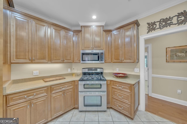 11 Creekwood Dr, Dublin, GA 31021 - kitchen featuring light tile patterned flooring, baseboards, ornamental molding, stainless steel appliances, and recessed lighting