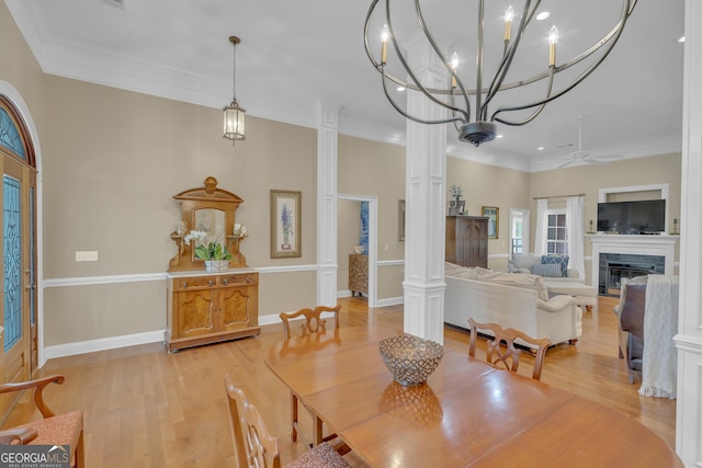 11 Creekwood Dr, Dublin, GA 31021 - dining room featuring crown molding, baseboards, light wood-style floors, ceiling fan with notable chandelier, and a glass covered fireplace