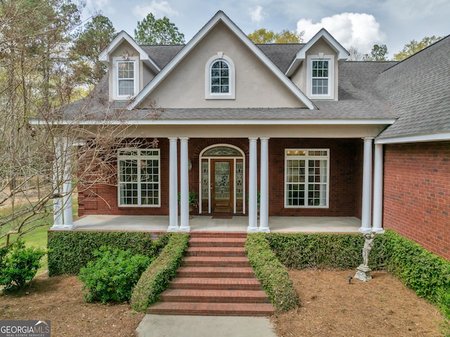 11 Creekwood Dr, Dublin, GA 31021 - view of front of house featuring covered porch, brick siding, and roof with shingles