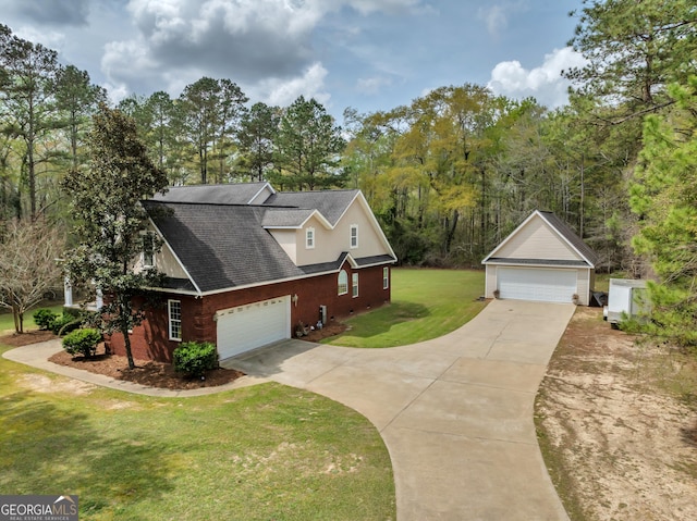 11 Creekwood Dr, Dublin, GA 31021 - view of side of property with a lawn, brick siding, a detached garage, and roof with shingles