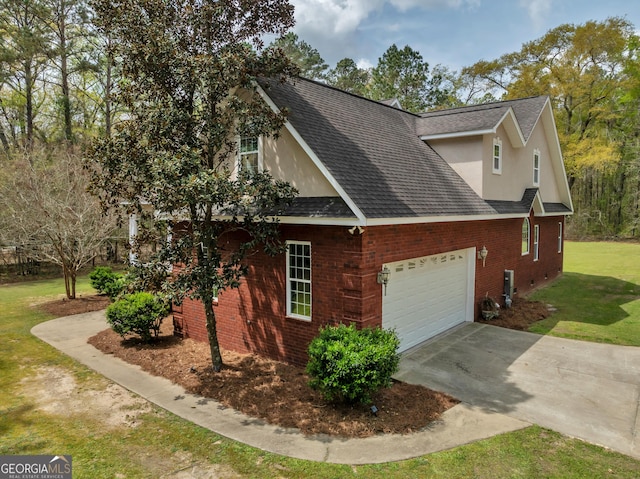 11 Creekwood Dr, Dublin, GA 31021 - view of side of property featuring roof with shingles, stucco siding, a yard, and an attached garage