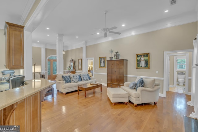 11 Creekwood Dr, Dublin, GA 31021 - living room with visible vents, light wood finished floors, ornate columns, ceiling fan, and ornamental molding