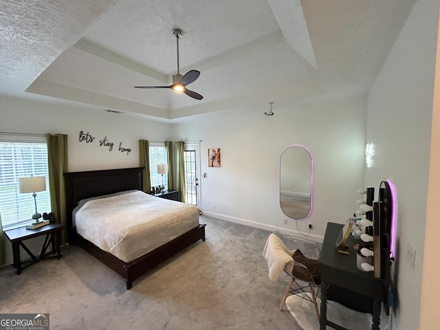 924 Morningside Dr, Griffin, GA 30224 - carpeted bedroom with a tray ceiling, multiple windows, baseboards, and a ceiling fan