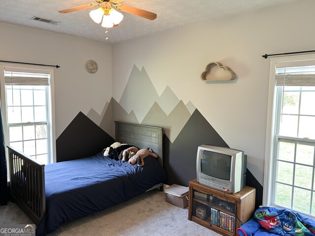 924 Morningside Dr, Griffin, GA 30224 - carpeted bedroom featuring a textured ceiling and ceiling fan
