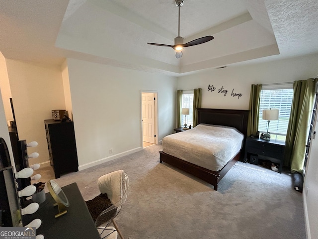 924 Morningside Dr, Griffin, GA 30224 - carpeted bedroom featuring a tray ceiling, baseboards, and a ceiling fan