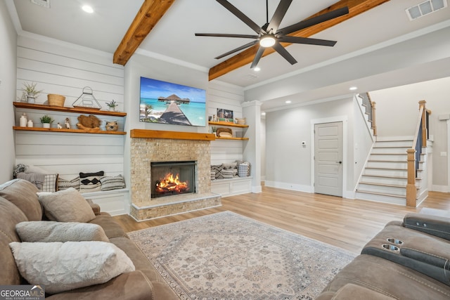 4426 Oxburgh Park, Flowery Branch, GA 30542 - living room featuring beam ceiling, light wood-style floors, ceiling fan, stairway, and a stone fireplace