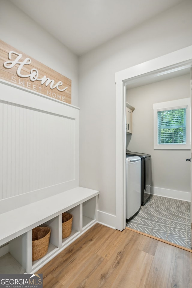 4426 Oxburgh Park, Flowery Branch, GA 30542 - laundry area with cabinet space, light wood-style floors, and washing machine and clothes dryer