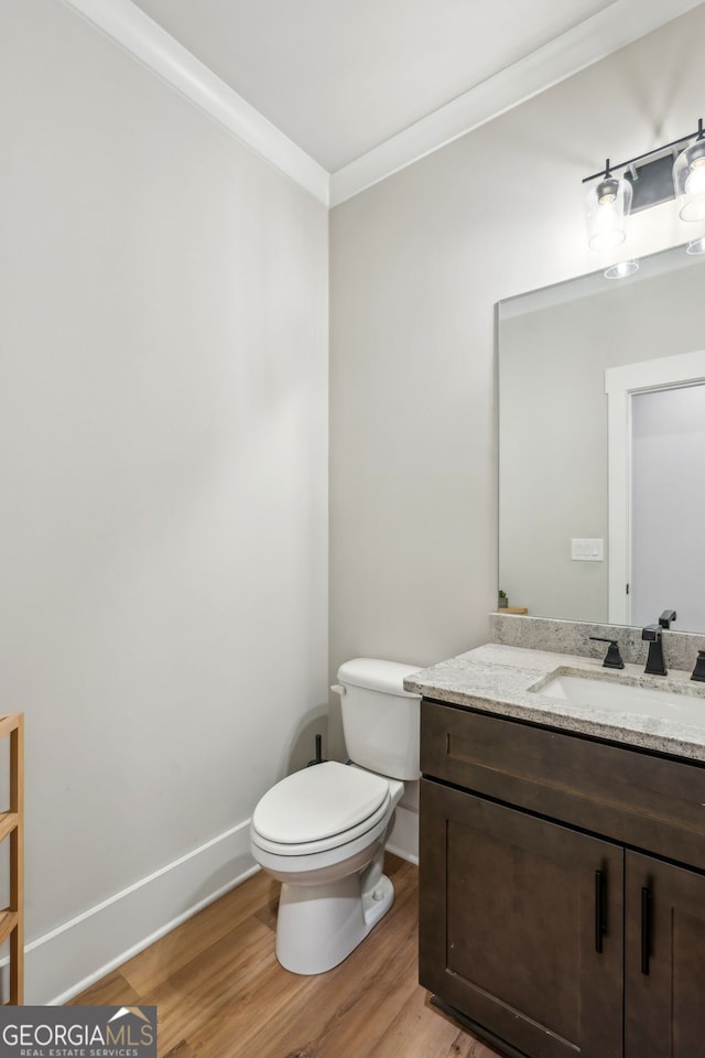 4426 Oxburgh Park, Flowery Branch, GA 30542 - half bath with vanity, wood finished floors, and crown molding