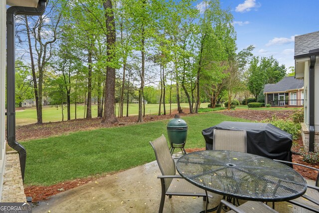 4426 Oxburgh Park, Flowery Branch, GA 30542 - view of patio featuring area for grilling, view of scattered trees, and outdoor dining area