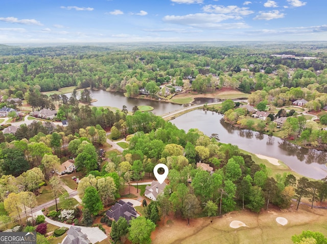 birds eye view of property with a forest view, a water view, and a residential view