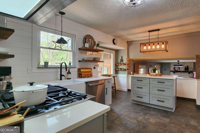 4295 S Berkeley Lake Rd NW, Berkeley Lake, GA 30096 - kitchen featuring stainless steel dishwasher, open shelves, light countertops, decorative light fixtures, and a textured ceiling