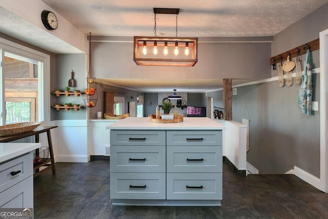 4295 S Berkeley Lake Rd NW, Berkeley Lake, GA 30096 - kitchen featuring light countertops, a textured ceiling, pendant lighting, wainscoting, and gray cabinetry