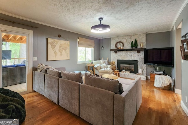 4295 S Berkeley Lake Rd NW, Berkeley Lake, GA 30096 - living area featuring wood finished floors, a fireplace, crown molding, and a textured ceiling