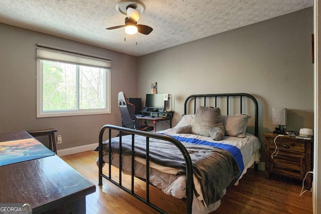 4295 S Berkeley Lake Rd NW, Berkeley Lake, GA 30096 - bedroom with a desk, wood finished floors, and ceiling fan