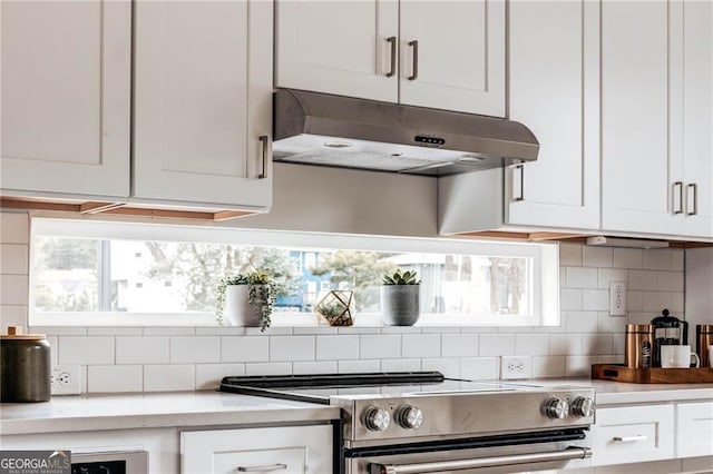 2029 Memorial Dr Unit 32, Atlanta, GA 30317 - kitchen featuring stainless steel electric range, under cabinet range hood, backsplash, and white cabinetry