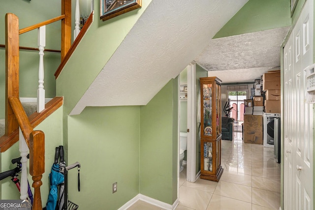105 Governors Dr, Forest Park, GA 30297 - corridor featuring stairway, baseboards, a textured ceiling, and light tile patterned floors