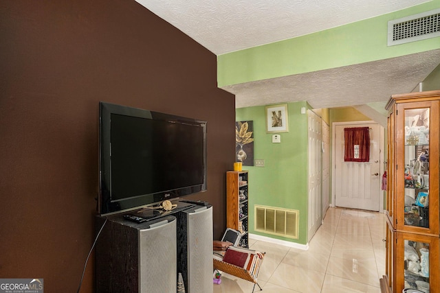 105 Governors Dr, Forest Park, GA 30297 - living area featuring visible vents, a textured ceiling, baseboards, and light tile patterned flooring
