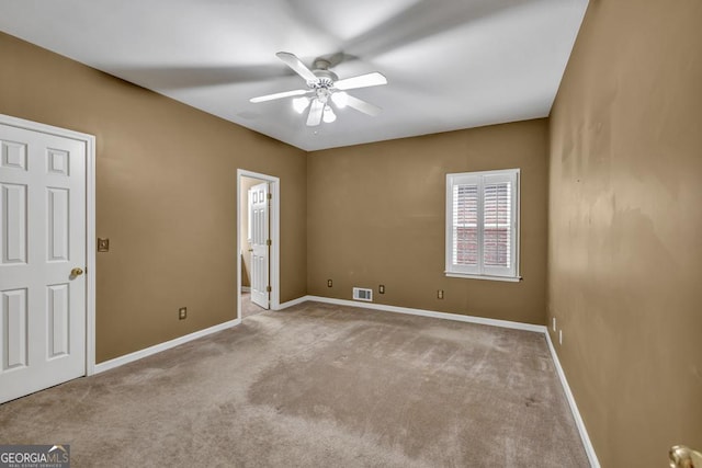 unfurnished bedroom with visible vents, baseboards, connected bathroom, a ceiling fan, and carpet floors