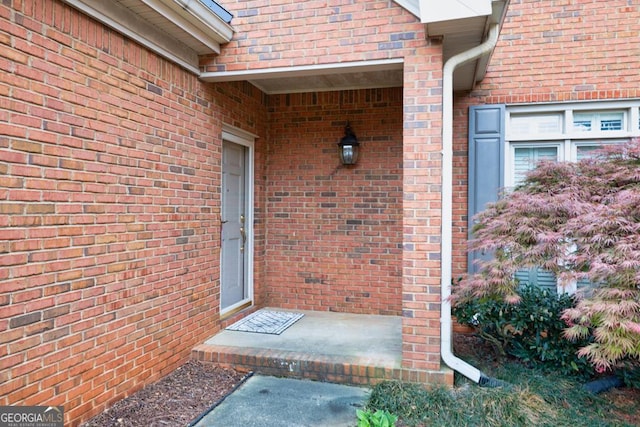 property entrance with brick siding