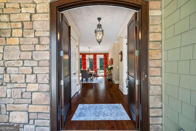 1462 Georgia Club Dr, Statham, GA 30666 - interior space with ornamental molding, baseboards, a chandelier, arched walkways, and wood finished floors