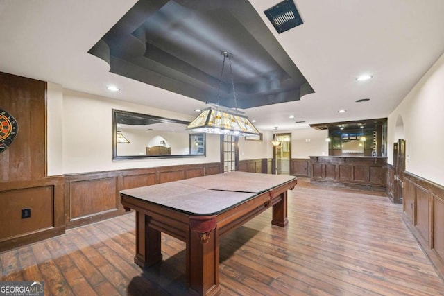 1462 Georgia Club Dr, Statham, GA 30666 - recreation room featuring wood-type flooring, a wainscoted wall, a tray ceiling, and visible vents
