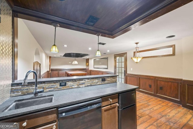 1462 Georgia Club Dr, Statham, GA 30666 - kitchen featuring hardwood / wood-style flooring, dark countertops, a sink, dishwashing machine, and wainscoting