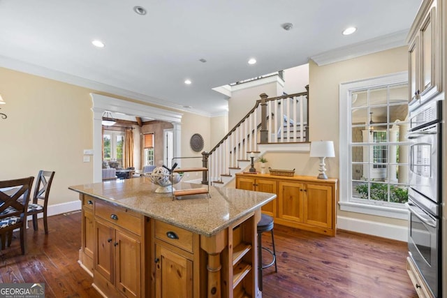 1462 Georgia Club Dr, Statham, GA 30666 - kitchen with baseboards, crown molding, dark wood-type flooring, and a kitchen island