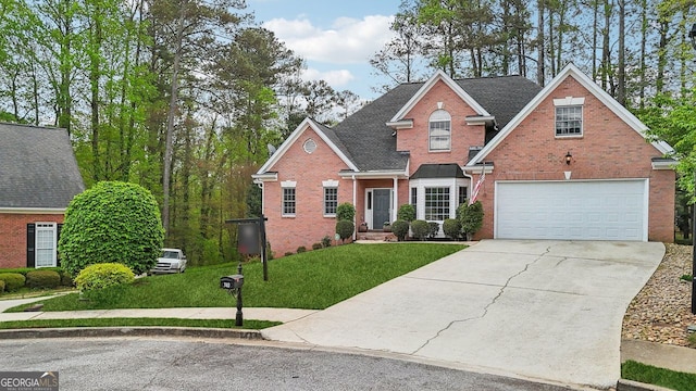 740 Trillium Ln, Lilburn, GA 30047 - traditional-style house featuring brick siding, driveway, a front lawn, a garage, and roof with shingles