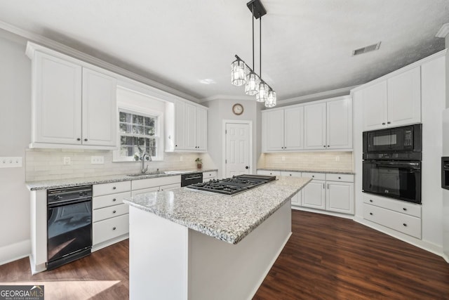 740 Trillium Ln, Lilburn, GA 30047 - kitchen with black appliances, a sink, a center island, dark wood-type flooring, and white cabinetry