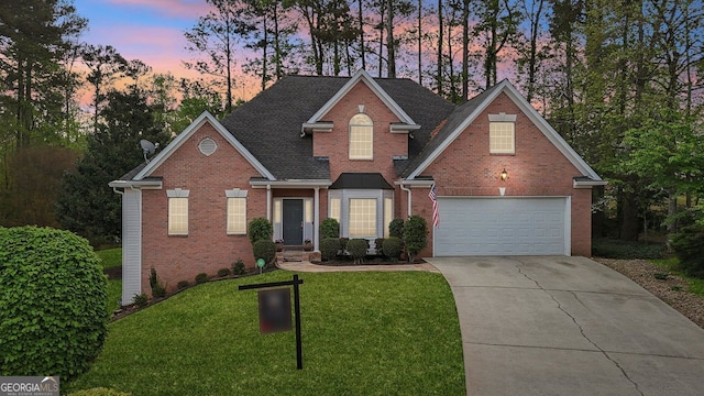 740 Trillium Ln, Lilburn, GA 30047 - traditional-style house featuring brick siding, concrete driveway, a front yard, and roof with shingles