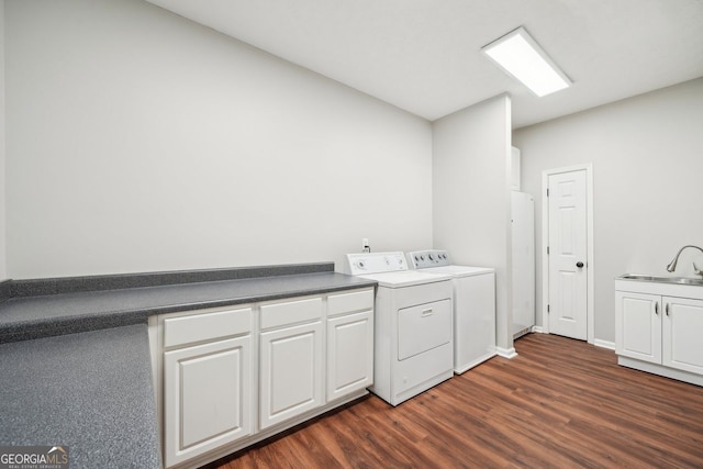 740 Trillium Ln, Lilburn, GA 30047 - laundry area featuring separate washer and dryer, dark wood finished floors, and cabinet space