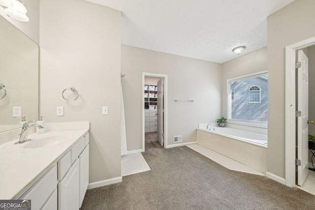 740 Trillium Ln, Lilburn, GA 30047 - full bathroom with carpet, vanity, a garden tub, and baseboards