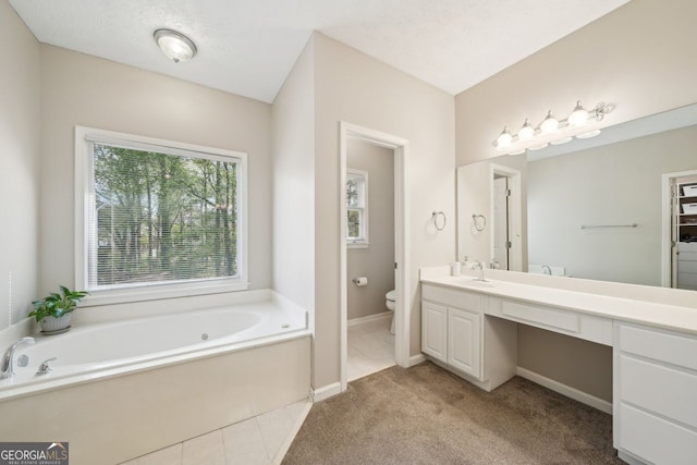 740 Trillium Ln, Lilburn, GA 30047 - full bath featuring toilet, a garden tub, vanity, and baseboards