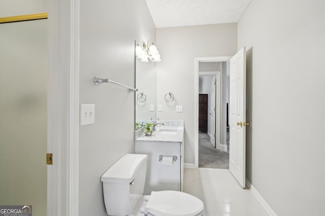 740 Trillium Ln, Lilburn, GA 30047 - bathroom with toilet, tile patterned floors, vanity, and baseboards