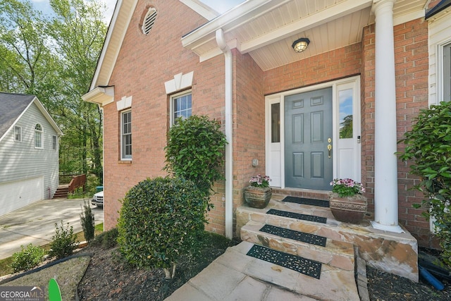 740 Trillium Ln, Lilburn, GA 30047 - view of exterior entry with brick siding and concrete driveway