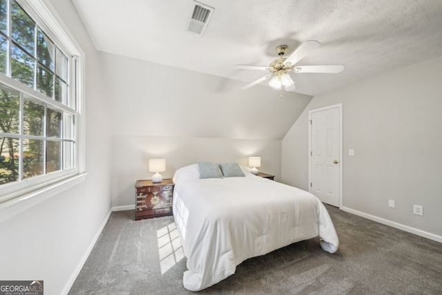 740 Trillium Ln, Lilburn, GA 30047 - carpeted bedroom featuring multiple windows, baseboards, ceiling fan, and vaulted ceiling