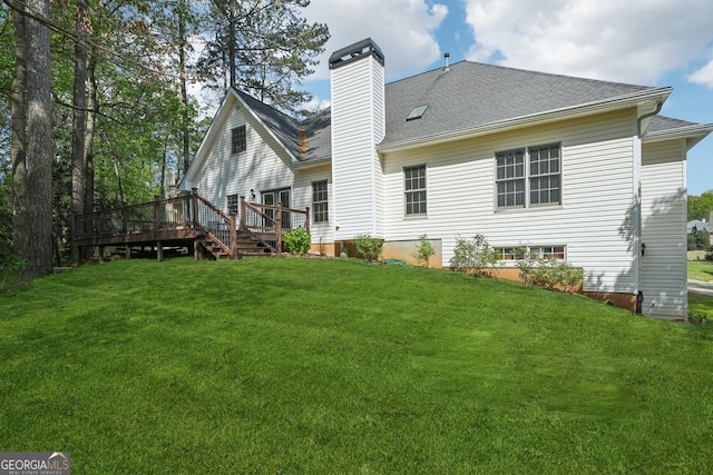 740 Trillium Ln, Lilburn, GA 30047 - back of house featuring a yard, a wooden deck, a chimney, and roof with shingles
