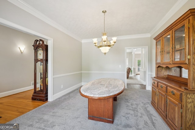 740 Trillium Ln, Lilburn, GA 30047 - carpeted dining area featuring crown molding, a chandelier, and baseboards
