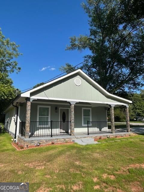 4321 Austell Powder Springs Rd SW, Powder Springs, GA 30127 - view of front facade featuring covered porch and a front yard