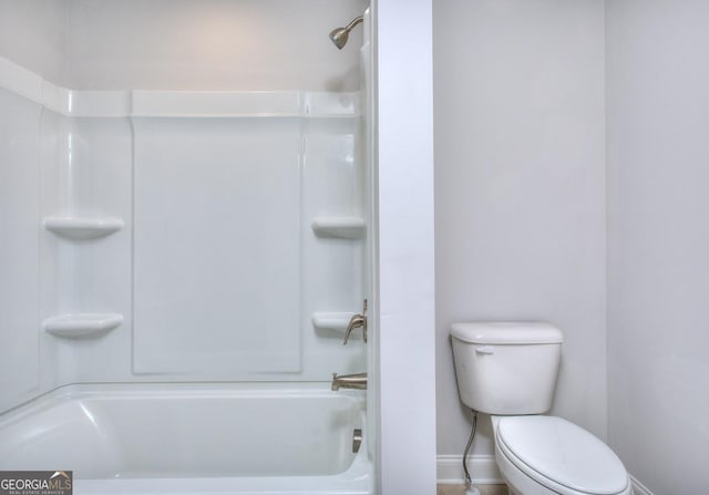 full bathroom with baseboards, toilet, and shower / bathing tub combination
