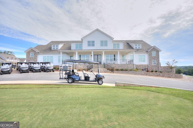 view of front facade with a front yard and stone siding