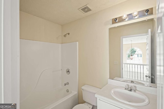 full bath with a textured ceiling, visible vents, washtub / shower combination, toilet, and vanity