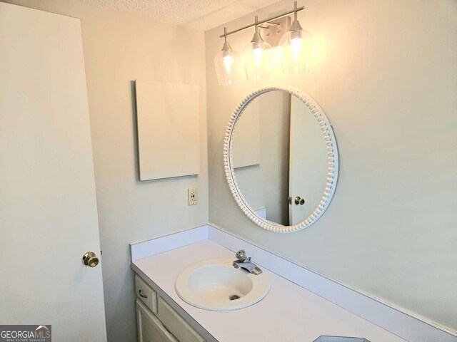 35 Rumson Ct SE, Smyrna, GA 30080 - bathroom with a textured ceiling and vanity