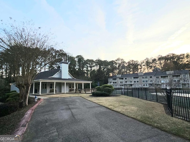 35 Rumson Ct SE, Smyrna, GA 30080 - exterior space featuring driveway, a porch, fence, and a chimney