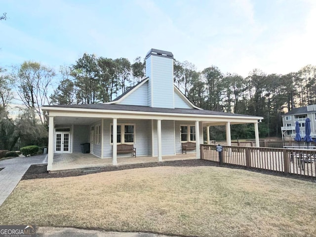 35 Rumson Ct SE, Smyrna, GA 30080 - view of front of home featuring a chimney, fence, french doors, and a front yard