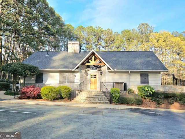 35 Rumson Ct SE, Smyrna, GA 30080 - view of front of home featuring a chimney, stone siding, and roof with shingles